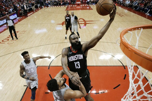 Houston Rockets guard James Harden (13) drives to the basket over Minnesota Timberwolves center Karl-Anthony Towns during the first half in Game 2 of a first-round NBA basketball playoff series Wednesday, April 18, 2018, in Houston. (AP Photo/Eric Christian Smith)