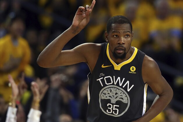 Golden State Warriors' Kevin Durant celebrates a score against the San Antonio Spurs during the second half in Game 2 of a first-round NBA basketball playoff series Monday, April 16, 2018, in Oakland, Calif. (AP Photo/Ben Margot)
