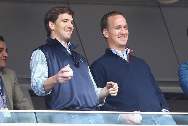NEW YORK, NY - MAY 04:  Eli Manning of the New York Giants and Peyton Manning of the Denver Broncos appear at the game between the New York Yankees and the Tampa Bay Rays  on May 4, 2014 in the Bronx borough of New York City.  (Photo by Al Bello/Getty Images)