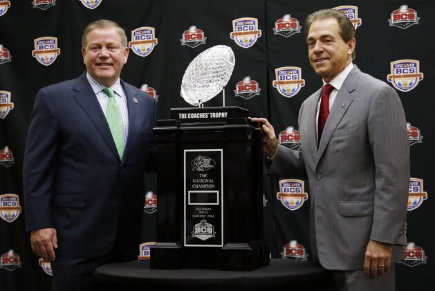 Alabama head coach Nick Saban and Notre Dame head coach Brian Kelly pose with The Coaches' Trophy during a news conference for the BCS National Championship college football game Sunday, Jan. 6, 2013, in Miami. (AP Photo/John Bazemore)