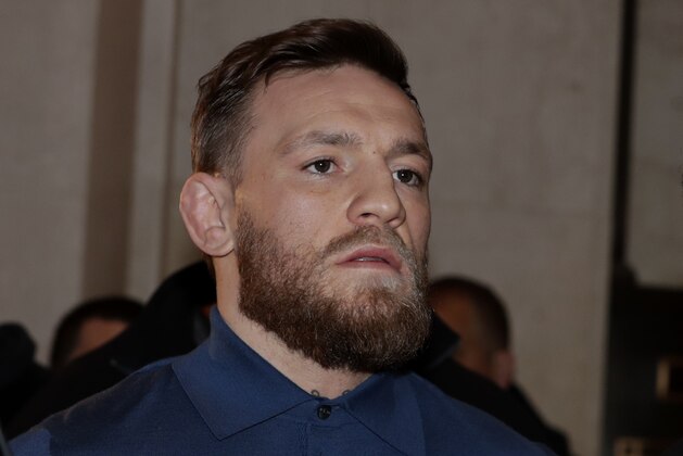 Ultimate fighting star Conor McGregor, center, is escorted by New York Court Police officers after a hearing at the Brooklyn Criminal Court, Friday, April 6, 2018, in New York. McGregor is facing criminal charges in the wake of a backstage melee he allegedly instigated that has forced the removal of three fights from UFC's biggest card of the year. Video footage appears to show the promotion's most bankable star throwing a hand truck at a bus full of fighters after a Thursday news conference for UFC 223 at Brooklyn's Barclays Center. (AP Photo/Julio Cortez)