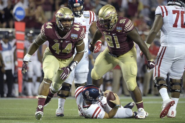Florida State defensive end DeMarcus Walker (44) and defensive tackle Derrick Nnadi (91) celebrate after sacking Mississippi quarterback Chad Kelly (10) during the second half of an NCAA college football game in Orlando, Fla., Monday, Sept. 5, 2016. Florida State won 45-34. (AP Photo/Phelan M. Ebenhack)