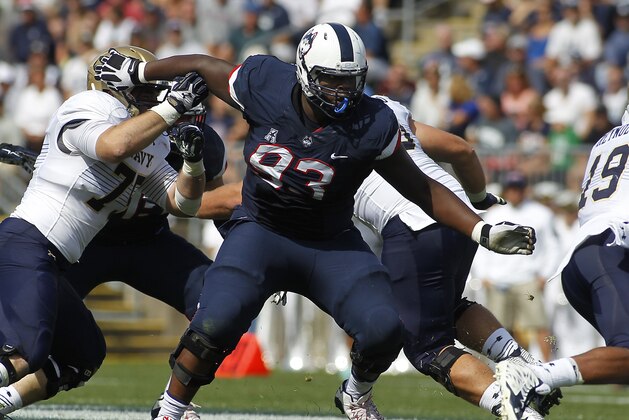 Connecticut defensive lineman Foley Fatukasi (93) during the second quarter of an NCAA college football game against Navy, Saturday, Sept. 26, 2015, in East Hartford, Conn. Three years after Superstorm Sandy forced his family from their home, Connecticut's Fatukasi has settled into a central part of the Huskies defensive line. (AP Photo/Stew Milne)