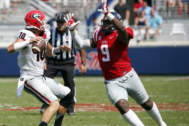 File-This Sept. 24, 2016, file photo shows Mississippi defensive tackle Breeland Speaks (9) rushing Georgia quarterback Jacob Eason (10) into a pass in the second half of their NCAA college football game in Oxford, Miss.  The Rebels have outscored opponents 41-6 in the first quarter and 107-33 in the first half. The second-half Rebels improved against Georgia. (AP Photo/Rogelio V. Solis, File)