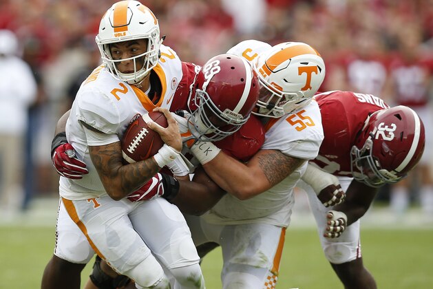 Alabama defensive lineman Joshua Frazier, center, tackles Tennessee quarterback Jarrett Guarantano, left, during the first half an NCAA college football game, Saturday, Oct. 21, 2017, in Tuscaloosa, Ala. (AP Photo/Brynn Anderson)