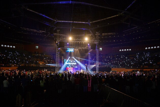 In this photograph taken on January 15, 2016, wrestler Roman Reigns (C-R) holds up the Championship Belt during the World Wrestling Entertainment (WWE) Live India Tour in New Delhi.    Enthusiastic fans flocked to the event as WWE returned to the country after an interval of 13 years.   AFP PHOTO/ CHANDAN KHANNA / AFP / Chandan Khanna        (Photo credit should read CHANDAN KHANNA/AFP/Getty Images)