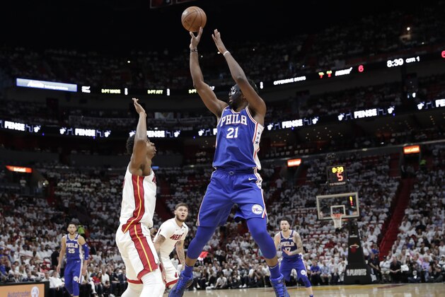 Philadelphia 76ers' Joel Embiid (21) shoots over Miami Heat's Hassan Whiteside, left, during the first half of Game 3 of a first-round NBA basketball playoff series Thursday, April 19, 2018, in Miami. (AP Photo/Lynne Sladky)