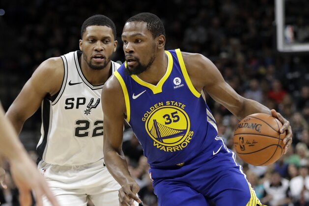 San Antonio Spurs' Rudy Gay (22) defends as Golden State Warriors' Kevin Durant (35) advances the ball up court in the first half of Game 3 of a first-round NBA basketball playoff series in San Antonio, Thursday, April 19, 2018. (AP Photo/Tony Gutierrez)