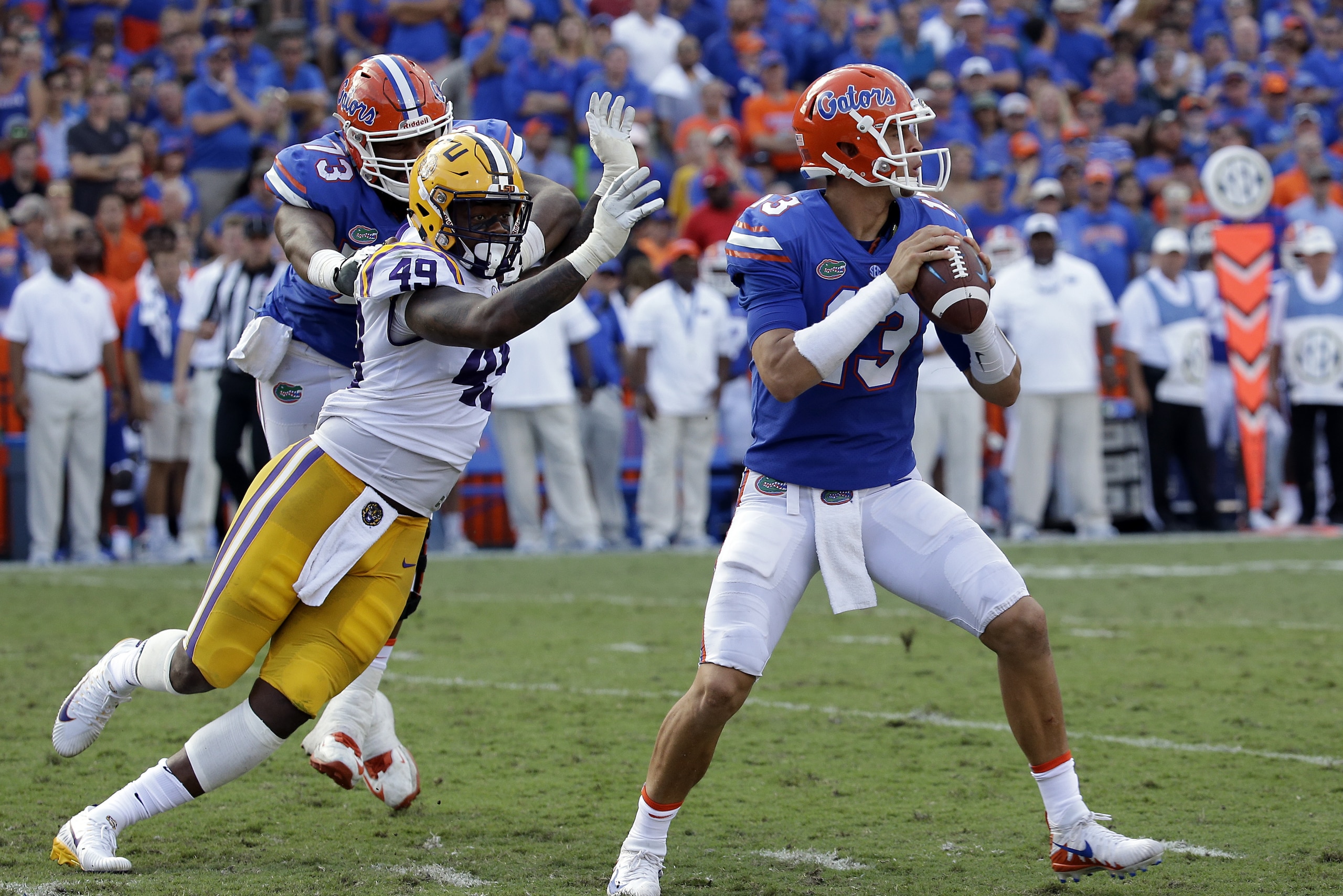 Florida quarterback Feleipe Franks (13) looks for a receiver as LSU linebacker Arden Key (49) puts on pressure during the first half of an NCAA college football game, Saturday, Oct. 7, 2017, in Gainesville, Fla.LSU won 17-16. (AP Photo/John Raoux)