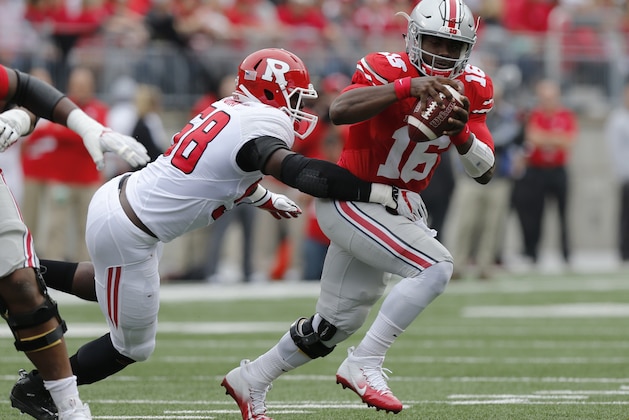Ohio State quarterback J.T. Barrett, right, scrambles away from Rutgers defensive lineman Kemoko Turay during the first half of an NCAA college football game Saturday, Oct. 1, 2016, in Columbus, Ohio. (AP Photo/Jay LaPrete)