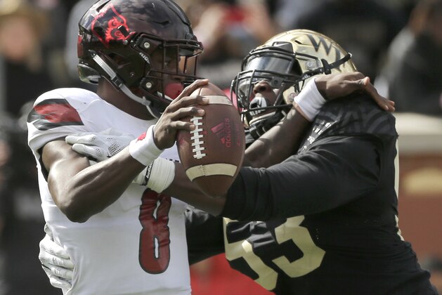 Louisville's Lamar Jackson (8) is sacked by Wake Forest's Duke Ejiofor (53) during the first half of an NCAA college football game in Winston-Salem, N.C., Saturday, Oct. 28, 2017. (AP Photo/Chuck Burton)