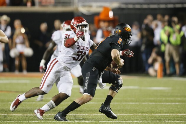 File-This Nov. 4, 2017, file photo shows Oklahoma defender Ogbonnia Okoronkwo (31) sacking Oklahoma State quarterback Mason Rudolph (2) during an NCAA college football game in Stillwater, Okla. Okoronkwo was selected to the AP All-America team announced Monday, Dec. 11, 2017.  (AP Photo/Sue Ogrocki, File)