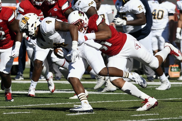 Murray State's Jordon Gandy (4) is brought down by Louisville's Trevon Young (91) during the first half of an NCAA college football game Saturday, Sept. 30, 2017, in Louisville, Ky. (AP Photo/Timothy D. Easley)