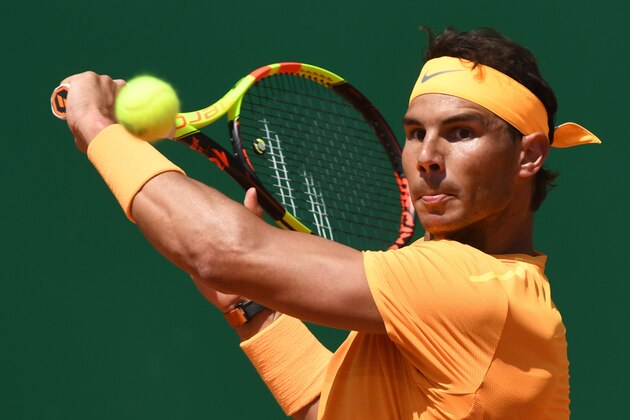 Spain's Rafael Nadal plays a backhand return to Austria's Dominic Thiem during their singles tennis match at the Monte-Carlo ATP Masters Series tournament in Monaco on April 20, 2018. (Photo by YANN COATSALIOU / AFP)        (Photo credit should read YANN COATSALIOU/AFP/Getty Images)