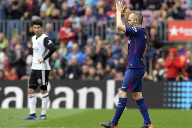 Barcelona's Spanish midfielder Andres Iniesta applauds as he leaves the pitch during the Spanish league footbal match between FC Barcelona and Valencia CF at the Camp Nou stadium in Barcelona on April 14, 2018. / AFP PHOTO / LLUIS GENE        (Photo credit should read LLUIS GENE/AFP/Getty Images)
