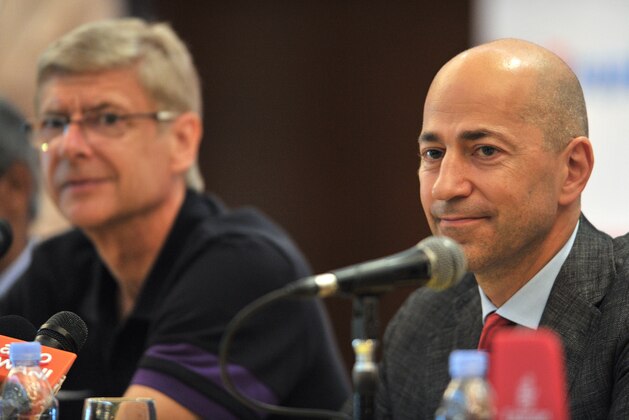 Chief Executive of Arsenal football club Ivan Gazidis (R) speaks while Arsenal manager Arsene Wenger (L) looks on during a press conference at a hotel in Selangor on July 22, 2012.  Arsenal are in the Malaysian capital Kuala Lumpur area to play Malaysia XI, a squad culled from the best players of the Malaysia Super League in a friendly which will take place on July 23.     AFP PHOTO / Mohd RASFAN        (Photo credit should read MOHD RASFAN/AFP/GettyImages)