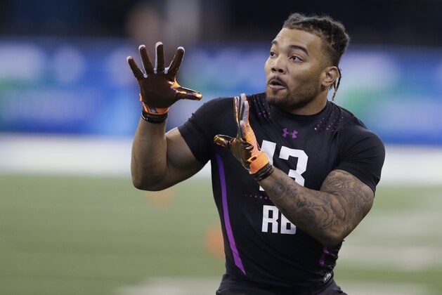 LSU running back Derrius Guice runs a drill during the NFL football scouting combine, Friday, March 2, 2018, in Indianapolis. (AP Photo/Darron Cummings)