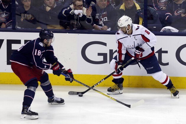 Washington Capitals forward Alex Ovechkin, right, of Russia, works against Columbus Blue Jackets forward Pierre-Luc Dubois during Game 3 of an NHL first-round hockey playoff series in Columbus, Ohio, Tuesday, April 17, 2018. The Capitals won 3-2 in double overtime. (AP Photo/Paul Vernon)