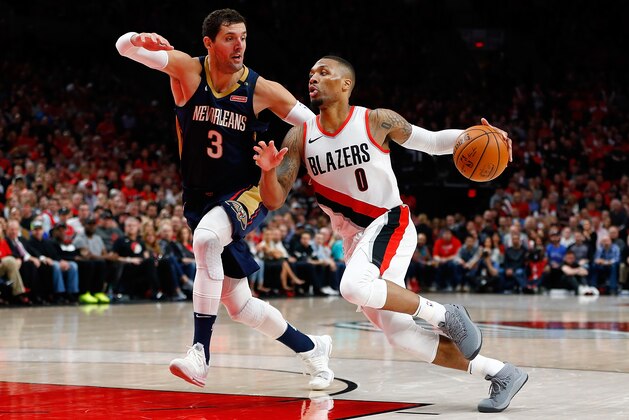 PORTLAND, OR - APRIL 17:  Nikola Mirotic #3 of the New Orleans Pelicans defends the shot of Damian Lillard #0 of  the Portland Trail Blazers during Game Two of the Western Conference Quarterfinals during the 2018 NBA Playoffs at Moda Center on April 17, 2018 in Portland, Oregon.  NOTE TO USER: User expressly acknowledges and agrees that, by downloading and or using this photograph, User is consenting to the terms and conditions of the Getty Images License Agreement.  (Photo by Jonathan Ferrey/Getty Images)