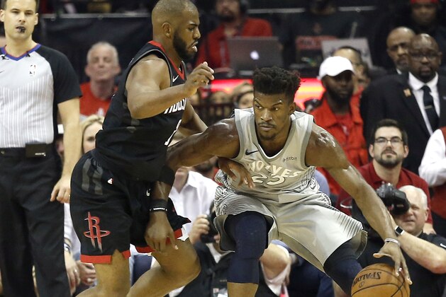 HOUSTON, TX - APRIL 18: Jimmy Butler #23 of the Minnesota Timberwolves backs in on Chris Paul #3 of the Houston Rockets during Game Two of the first round of the Western Conference playoffs at Toyota Center on April 18, 2018 in Houston, Texas. NOTE TO USER: User expressly acknowledges and agrees that, by downloading and or using this photograph, User is consenting to the terms and conditions of the Getty Images License Agreement. (Photo by Bob Levey/Getty Images)