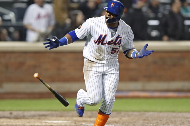 New York Mets' Yoenis Cespedes looks toward the Mets' dugout after hitting an eighth-inning grand slam in a baseball game against the Washington Nationals, Wednesday, April 18, 2018, in New York. (AP Photo/Kathy Willens)
