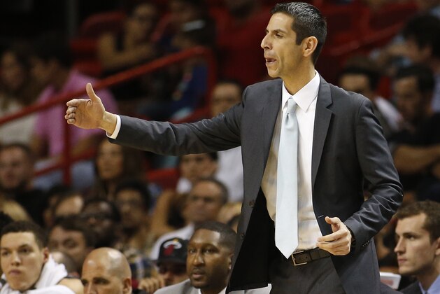 CORRECTS DAY OF WEEK- Orlando Magic’s head coach James Borrego directs the players during the second half of an NBA basketball game against the Miami Heat, Monday, April 13, 2015, in Miami. (AP Photo/Joel Auerbach)