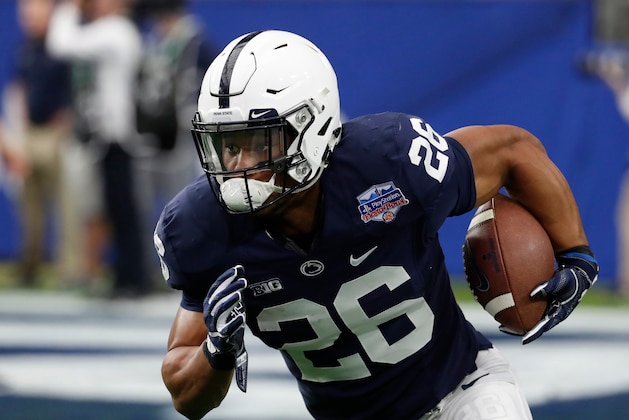 FILE - In this Dec. 30, 2017 file photo Penn State running back Saquon Barkley (26) runs the ball against Washington during the Fiesta Bowl NCAA college football game in Glendale, Ariz. Barkley is a top prospect in the upcoming NFL draft. (AP Photo/Rick Scuteri, file)