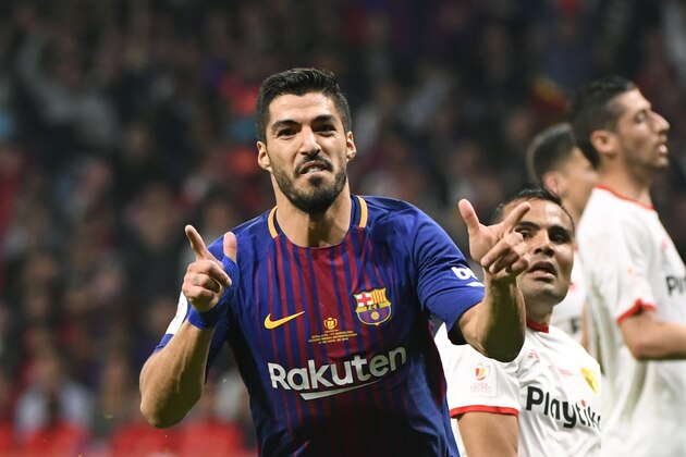 Barcelona's Uruguayan forward Luis Suarez (L) celebrates after scoring his second goal during the Spanish Copa del Rey (King's Cup) final football match Sevilla FC against FC Barcelona at the Wanda Metropolitano stadium in Madrid on April 21, 2018. (Photo by PIERRE-PHILIPPE MARCOU / AFP)        (Photo credit should read PIERRE-PHILIPPE MARCOU/AFP/Getty Images)