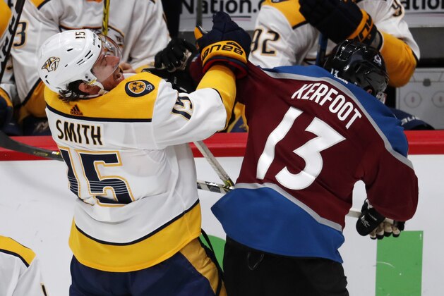Nashville Predators right wing Craig Smith, left, reacts as he gets hit by Colorado Avalanche center Alexander Kerfoot during the third period of Game 4 of an NHL hockey first-round playoff series Wednesday, April 18, 2018, in Denver. The Predators won 3-2. (AP Photo/David Zalubowski)