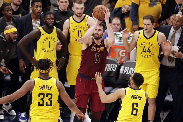 Cleveland Cavaliers' Kevin Love (0) shoots over Indiana Pacers center Myles Turner (33) and guard Cory Joseph (6) during the second half of Game 3 of an NBA basketball first-round playoff series in Indianapolis, Friday, April 20, 2018. The Pacers won 92-90 to take a 2-1 lead in the series. (AP Photo/Michael Conroy)