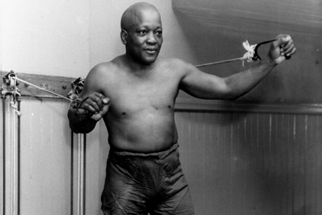 FILE - In this 1932 file photo, boxer Jack Johnson, the first black world heavyweight champion, poses in New York City.  Black athletes have been finding a way to fight for social change for more than 100 years, from Jack Johnson, to Muhammad Ali to Kaepernick. (AP Photo/File)
