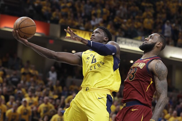 Indiana Pacers' Victor Oladipo (4) shoots in front of Cleveland Cavaliers' LeBron James during the second half of Game 3 of a first-round NBA basketball playoff series, Friday, April 20, 2018, in Indianapolis. Indiana won 92-90. (AP Photo/Darron Cummings)