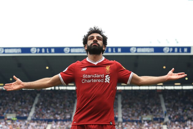 Liverpool's Egyptian midfielder Mohamed Salah celebrates scoring their second goal during the English Premier League football match between West Bromwich Albion and Liverpool at The Hawthorns stadium in West Bromwich, central England, on April 21, 2018. (Photo by Lindsey PARNABY / AFP) / RESTRICTED TO EDITORIAL USE. No use with unauthorized audio, video, data, fixture lists, club/league logos or 'live' services. Online in-match use limited to 75 images, no video emulation. No use in betting, games or single club/league/player publications. /         (Photo credit should read LINDSEY PARNABY/AFP/Getty Images)