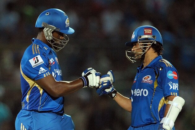 Mumbai Indians batsmen Sachin Tendulkar (R) and Dwayne Smith (L) react during the IPL Twenty20 cricket match between Rajasthan Royals and Mumbai Indians at the Sawai Man Singh stadium in Jaipur on May 20, 2012.     AFP PHOTO/ MANAN VATSYAYANA     RESTRICTED TO EDITORIAL USE. MOBILE USE WITHIN NEWS PACKAGE        (Photo credit should read MANAN VATSYAYANA/AFP/GettyImages)