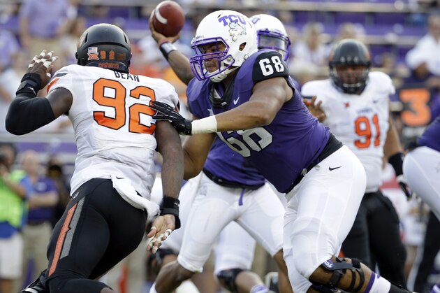 TCU offensive tackle Joseph Noteboom (68) defends against a rush by Oklahoma State defensive end Jimmy Bean (92) during an NCAA college football game, Saturday, Oct. 18, 2014, in Fort Worth, Texas. (AP Photo/Tony Gutierrez)