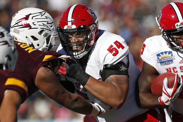 North Carolina State offensive tackle Will Richardson (54) blocks Arizona State tight end Jay Jay Wilson (9) to prevent a tackle on running back Reggie Gallaspy (25) during the first half of the Sun Bowl NCAA college football game in El Paso, Texas, Friday, Dec. 29, 2017. (AP Photo/Andres Leighton)