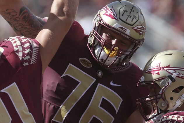 Florida State's Ryan Izzo celebrates his touchdown reception with teammate Rick Leonard during an NCAA college football game with Louisville, Saturday, Oct. 21, 2017, in Tallahassee Fla. Louisville won 31-28. (AP Photo/Steve Cannon)