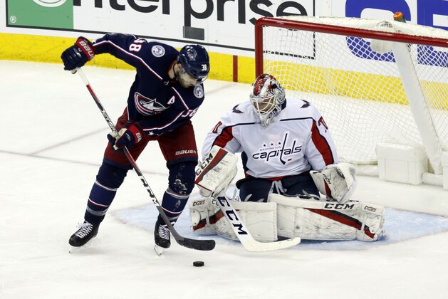 Washington Capitals goalie Braden Holtby, right, stops a shot by Columbus Blue Jackets forward Boone Jenner during Game 3 of an NHL first-round hockey playoff series in Columbus, Ohio, Tuesday, April 17, 2018. The Capitals won 3-2 in double overtime. (AP Photo/Paul Vernon)