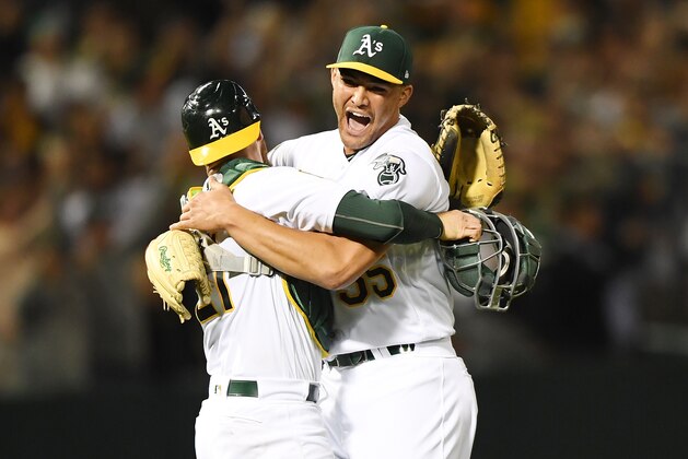 OAKLAND, CA - APRIL 21:  Sean Manaea #55 and Jonathan Lucroy #21 of the Oakland Athletics celebrates after Manaea pitched a no-hitter against the Boston Red Sox at the Oakland Alameda Coliseum on April 21, 2018 in Oakland, California. The Athletics won the game 3-0.  (Photo by Thearon W. Henderson/Getty Images)