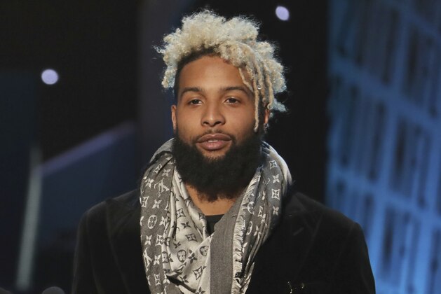 In this photo provided by the NFL, Lea Michele, left, and Odell Beckham Jr. of the New York Giants present the award for The Associated Press 2017 NFL Defensive Rookie of the Year at the 7th Annual NFL Honors at the Cyrus Northrop Memorial Auditorium on Saturday, Feb. 3, 2018, in Minneapolis. (Photo by Michael Zorn/Invision for NFL/AP Images)
