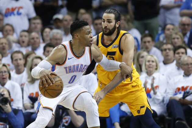Oklahoma City Thunder guard Russell Westbrook (0) drives against Utah Jazz guard Ricky Rubio, right, during Game 2 of an NBA basketball first-round playoff series between the Utah Jazz and the Oklahoma City Thunder in Oklahoma City, Wednesday, April 18, 2018. (AP Photo/Sue Ogrocki)