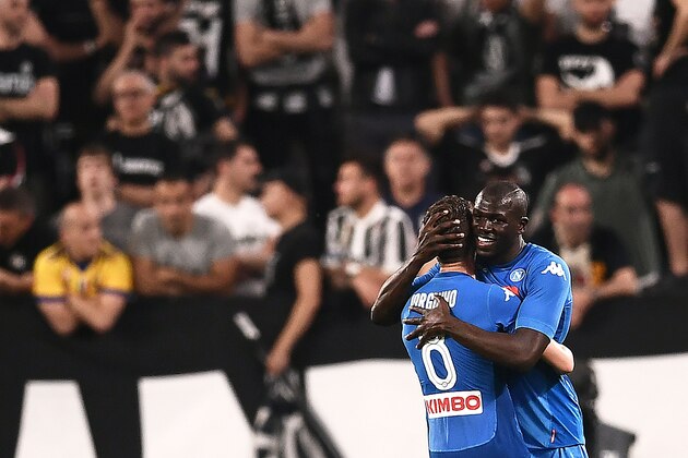 Napoli's French defender Kalidou Koulibaly (R) celebrates with teammate Italian midfielder Jorginho (L) after scoring a goal during the Italian Serie A football match between Juventus and Napoli on April 22, 2018 at the Allianz Stadium in Turin. (Photo by MARCO BERTORELLO / AFP)        (Photo credit should read MARCO BERTORELLO/AFP/Getty Images)