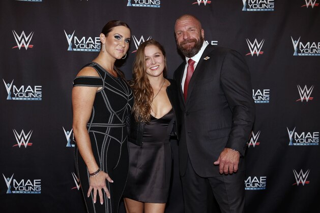 IMAGE DISTRIBUTED FOR WWE - WWE Chief Brand Officer Stephanie McMahon, left, Ronda Rousey, center, and WWE EVP of Talent, Live Events and Creative Paul