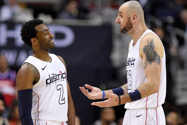 Washington Wizards guard John Wall (2) smiles next to Marcin Gortat (13) during the second half of Game 3 of an NBA basketball first-round playoff series against the Toronto Raptors, Friday, April 20, 2018, in Washington. The Wizards won 122-103. (AP Photo/Nick Wass)