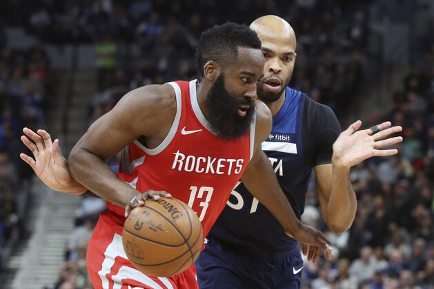 Houston Rockets' James Harden, left, drives around Minnesota Timberwolves' Taj Gibson during the second half of Game 3 in an NBA basketball first-round playoff series Saturday, April 21, 2018, in Minneapolis. The Timberwolves won 121-105. (AP Photo/Jim Mone)