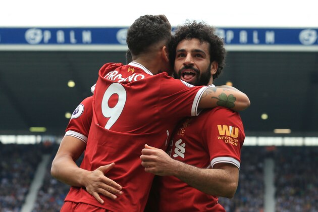 Liverpool's Egyptian midfielder Mohamed Salah (R) celebrates scoring their second goal during the English Premier League football match between West Bromwich Albion and Liverpool at The Hawthorns stadium in West Bromwich, central England, on April 21, 2018. (Photo by Lindsey PARNABY / AFP) / RESTRICTED TO EDITORIAL USE. No use with unauthorized audio, video, data, fixture lists, club/league logos or 'live' services. Online in-match use limited to 75 images, no video emulation. No use in betting, games or single club/league/player publications. /         (Photo credit should read LINDSEY PARNABY/AFP/Getty Images)