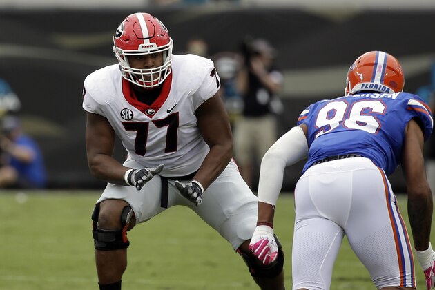 File-This Oct. 28, 2017, file photo shows Georgia offensive tackle Isaiah Wynn (77) looking to block Florida defensive lineman Cece Jefferson (96) in the first half of an NCAA college football game, in Jacksonville, Fla. Wynn was selected to the AP All-America team announced Monday, Dec. 11, 2017.  (AP Photo/John Raoux, File)