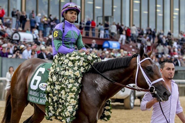 HOT SPRINGS, AR - APRIL 14: Magnum Moon #6, with jockey Luis Saez, heads to the winner's circle after winning the Arkansas Derby at Oaklawn Park on April 14, 2018 in Hot Springs, Arkansas. (Photo by Justin Manning/Eclipse Sportswire/Getty Images)