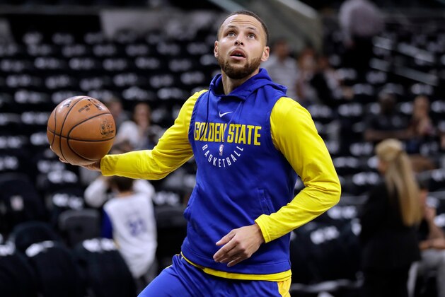 FILE - In this April 19, 2018 file photo, Golden State Warriors guard Stephen Curry (30) warms up before Game 3 of the team's first-round NBA basketball playoff series against the San Antonio Spurs in San Antonio.  Curry has been cleared to take part in modified practices but will be out at least one more week with a left knee injury. The Warriors said Curry was examined by the team's medical staff Friday and is making progress in recovering from the grade 2 left MCL sprain that has sidelined him since March 23.(AP Photo/Eric Gay)