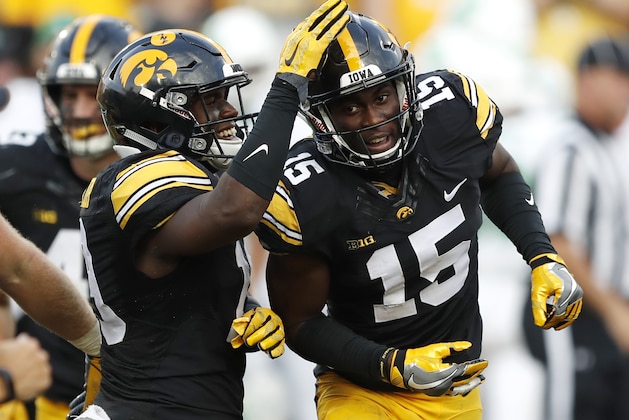 FILE - In this Sept. 16, 2017, file photo, Iowa's Josh Jackson (15) celebrates with teammate Miles Taylor, left, after intercepting a pass during the second half of an NCAA college football game against North Texas, in Iowa City, Iowa. Jackson was selected to the 2017 AP All-Conference Big Ten team announced Wednesday, Dec. 6, 2017. (AP Photo/Charlie Neibergall, File)